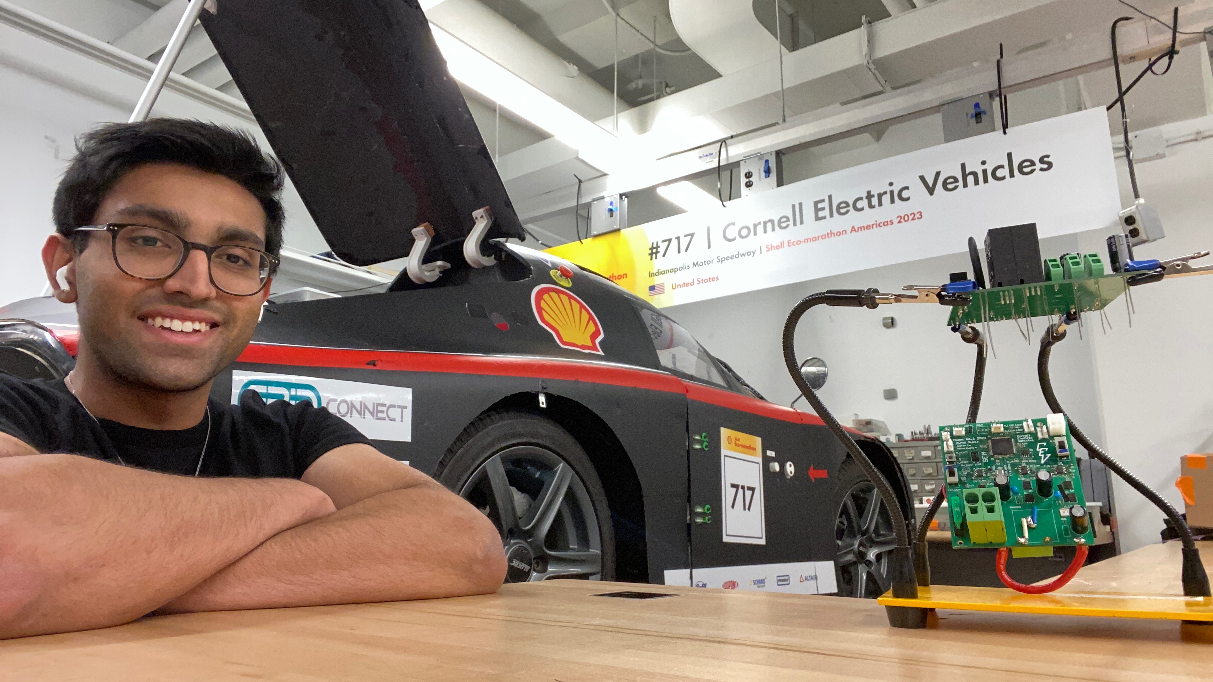 Kunal with the racecar and a controller board