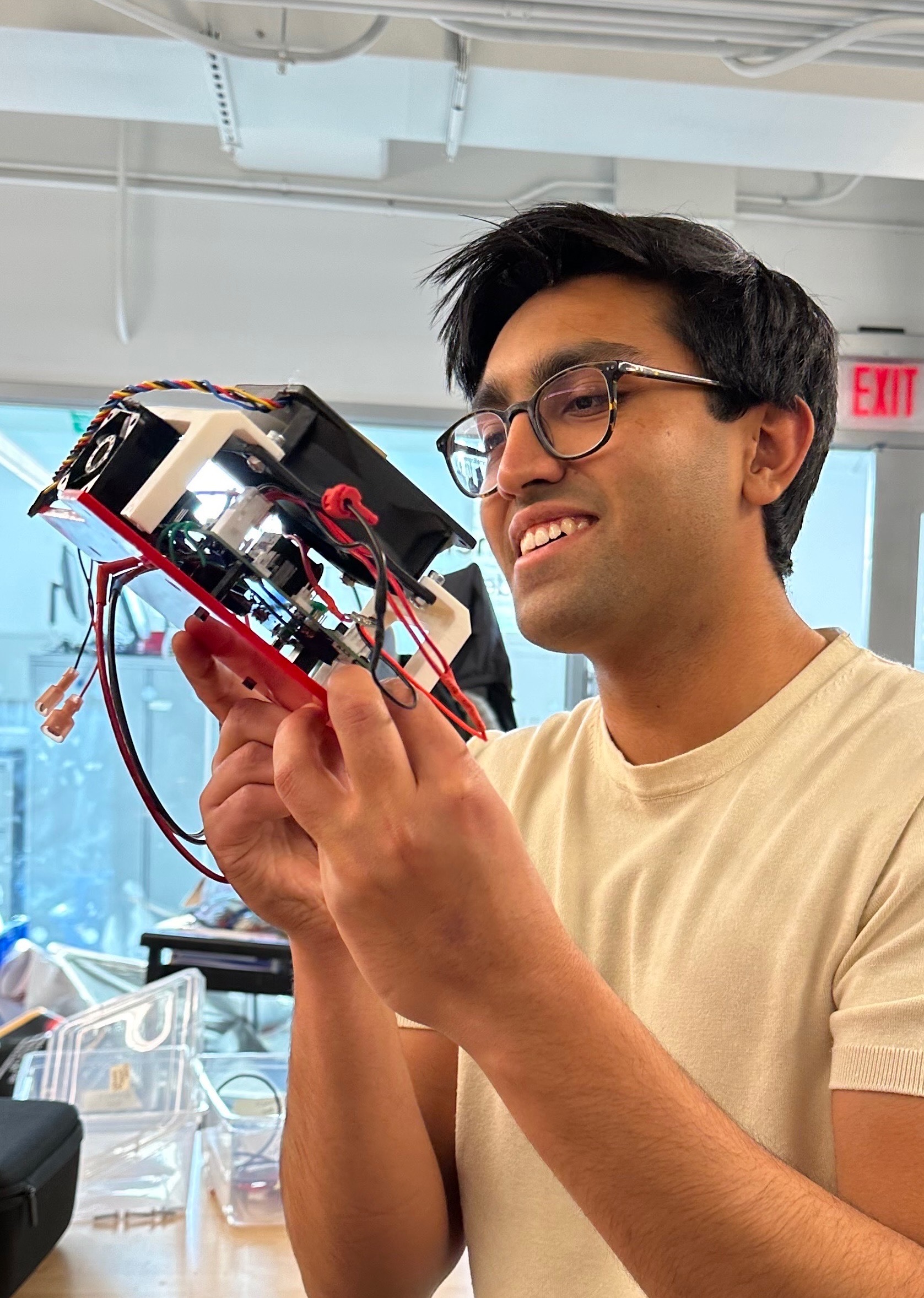 Kunal holding an early electronics prototype
