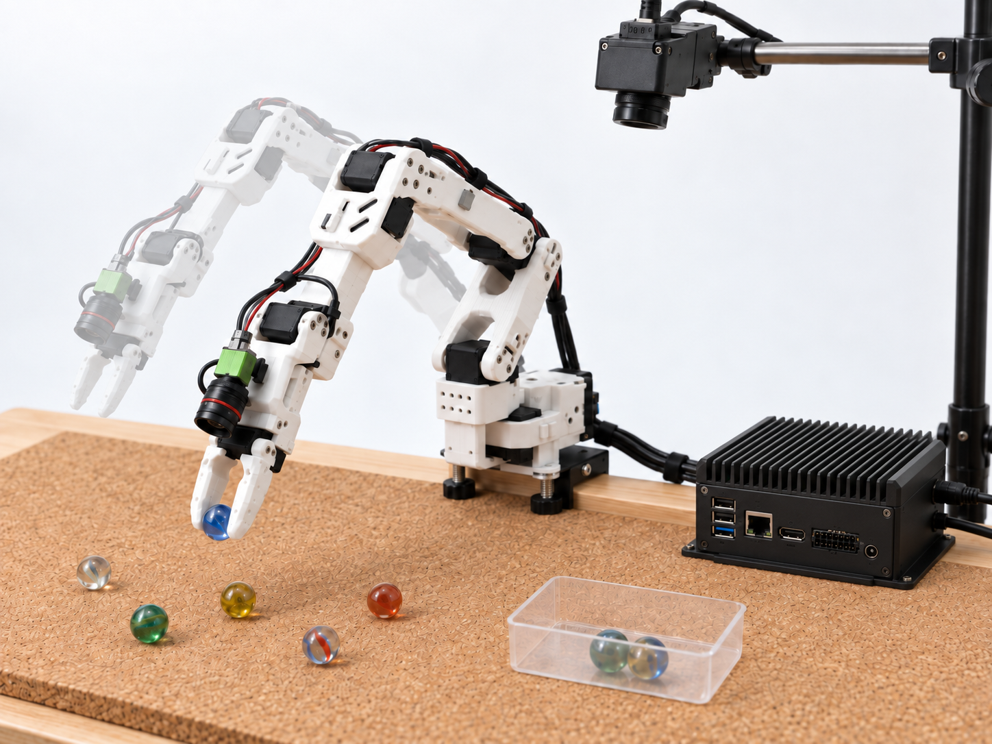 Robot arm using a camera to sort marbles on a workbench