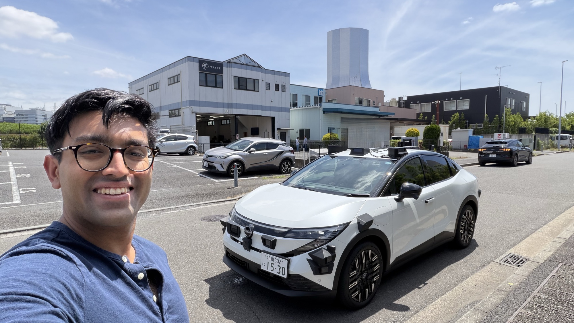 Kunal with Wayve robotaxis in Japan